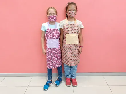 Sew & Grow student &mdash; aprons they cut and sewed
