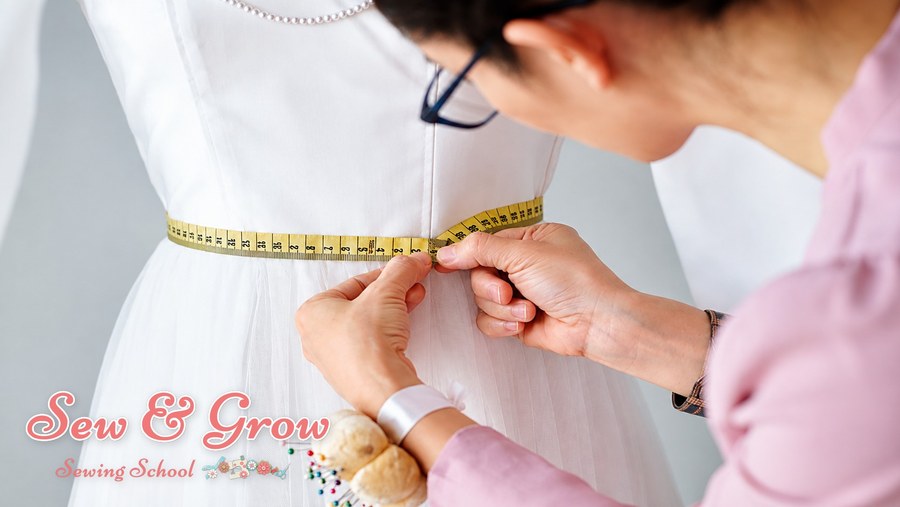 Measuring the waist of a white dress with a tape measure