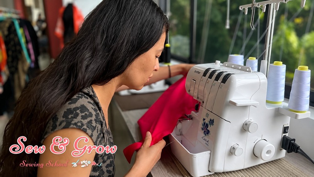 A sewer finishing bright fabric on an overlocker